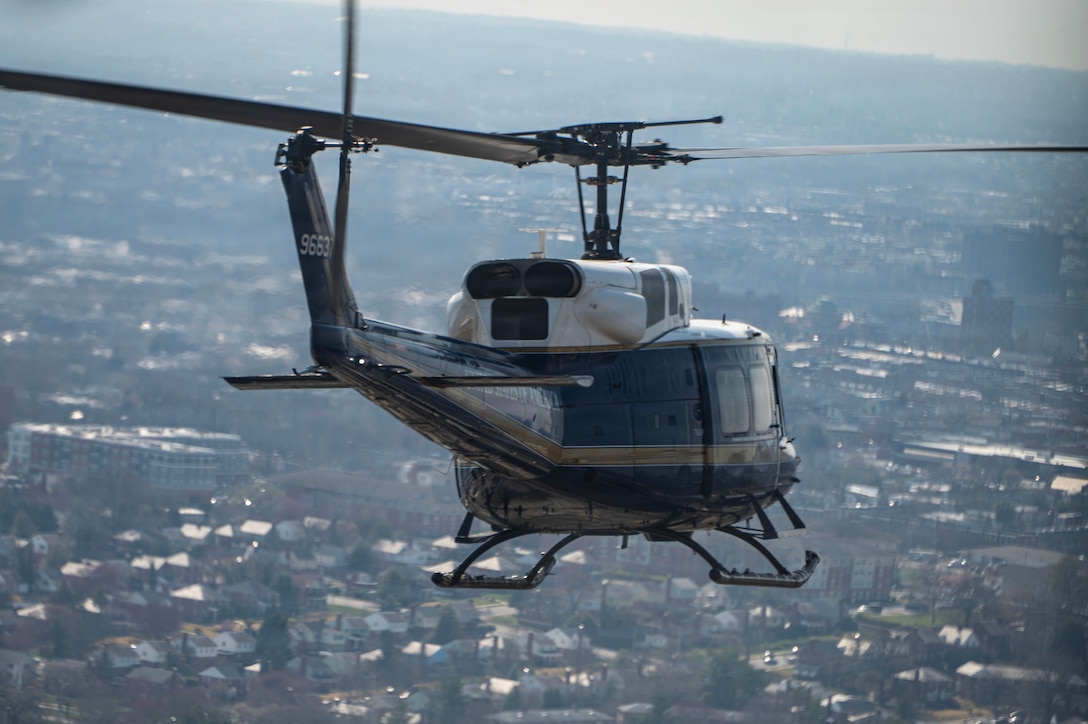 A UH-1N Huey assigned to the 1st Helicopter Squadron flies toward Oriole Park at Camden Yards, Maryland, to conduct a flyover for the Baltimore Orioles opening game, March 26, 2026. Joint Base Andrews supports flyovers for community events to showcase trained aviation, support recruitment, and boost patriotism. (U.S. Air Force photo by Staff Sgt. Aubree Owens)