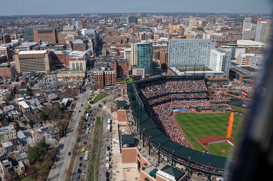 Two UH-1N Hueys, assigned to the 1st Helicopter Squadron, fly over the Baltimore Orioles versus the Minnesota Twins opening game at Oriole Park, Camden Yards, Maryland, March 26, 2026. The event showcased the planning and teamwork between the 1st HS and game officials to synchronize the flyover with the pregame ceremony. (U.S. Air Force photo by Staff Sgt. Aubree Owens)