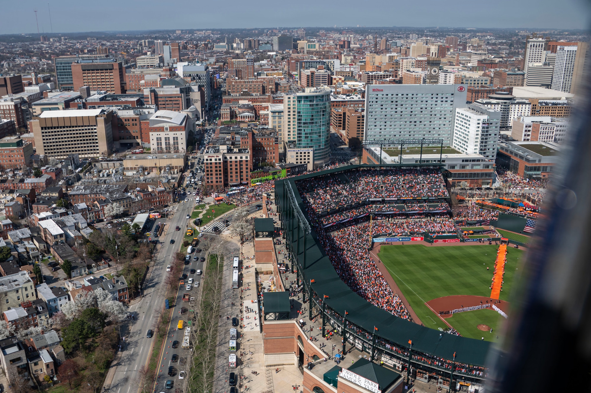 Two UH-1N Hueys, assigned to the 1st Helicopter Squadron, fly over the Baltimore Orioles versus the Minnesota Twins opening game at Oriole Park, Camden Yards, Maryland, March 26, 2026. The event showcased the planning and teamwork between the 1st HS and game officials to synchronize the flyover with the pregame ceremony. (U.S. Air Force photo by Staff Sgt. Aubree Owens)