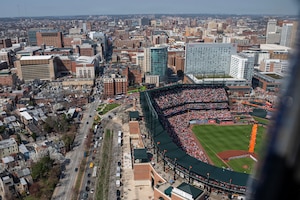 Two UH-1N Hueys, assigned to the 1st Helicopter Squadron, fly over the Baltimore Orioles versus the Minnesota Twins opening game at Oriole Park, Camden Yards, Maryland, March 26, 2026. The event showcased the planning and teamwork between the 1st HS and game officials to synchronize the flyover with the pregame ceremony. (U.S. Air Force photo by Staff Sgt. Aubree Owens)
