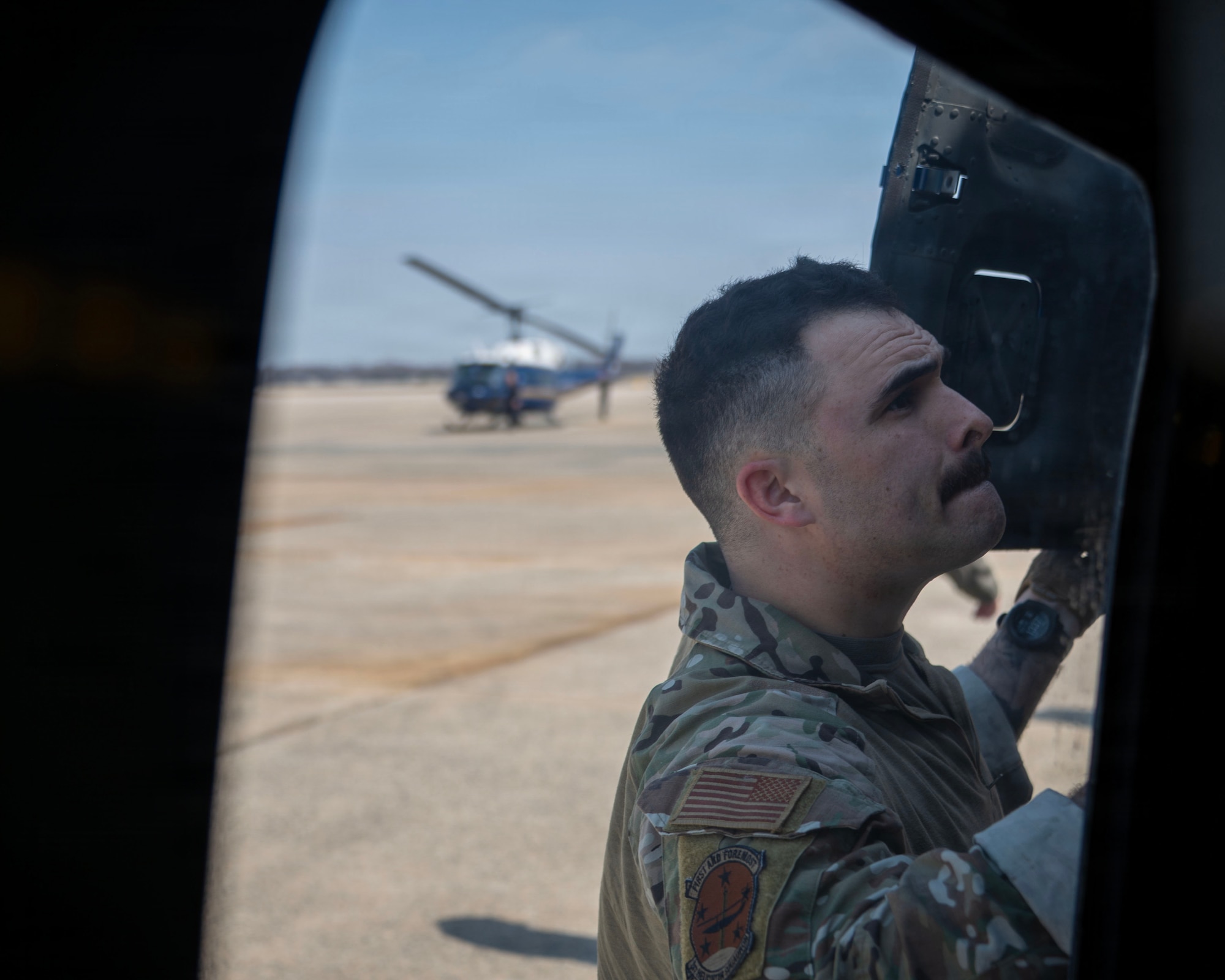 U.S. Air Force 1st Lt. Jake Streibich, a mission pilot assigned to the 1st Helicopter Squadron, conducts a pre-flight inspection prior to a flight at Joint Base Andrews, Maryland, March 26, 2026. The 1st HS conducts rotary-wing airlift, security and contingency operations in support of Joint Base Andrews and the National Capital Region. (U.S. Air Force photo by Staff Sgt. Aubree Owens)