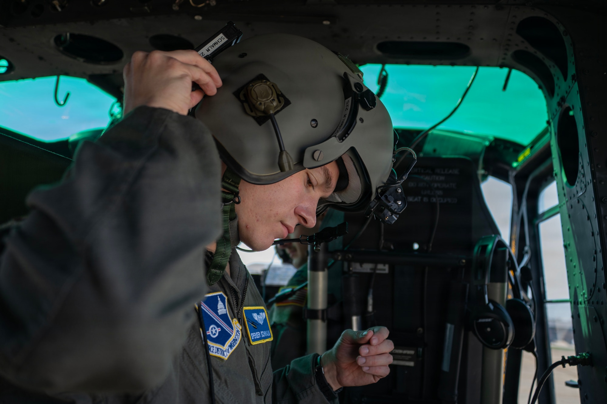 U.S. Air Force 1st Lt. Spenser Schwalm, a mission pilot assigned to the 1st Helicopter Squadron, prepares for a flight at Joint Base Andrews, Maryland, March 26, 2026. The 1st HS conducts rotary-wing airlift, security and contingency operations in support of Joint Base Andrews and the National Capital Region. (U.S. Air Force photo by Staff Sgt. Aubree Owens)