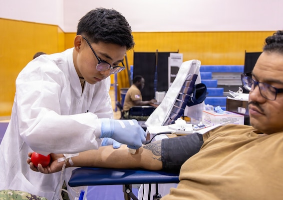 YOKOSUKA, Japan (Feb. 25, 2026) — A laboratory technician prepares a donor for blood collection during a two-day blood drive at Yokosuka’s Fleet Recreation Gym. U.S. Naval Hospital (USNH) Yokosuka, in partnership with the Armed Services Blood Bank Center (ASBBC) Okinawa, hosted a two-day blood drive at Commander, Fleet Activities Yokosuka’s Fleet Recreation Gym, Feb. 25–26, collecting 179 units of whole blood in support of operational readiness across the Indo-Pacific region. (U.S. Navy photo by Daniel Taylor/USNMRTC Yokosuka Public Affairs)