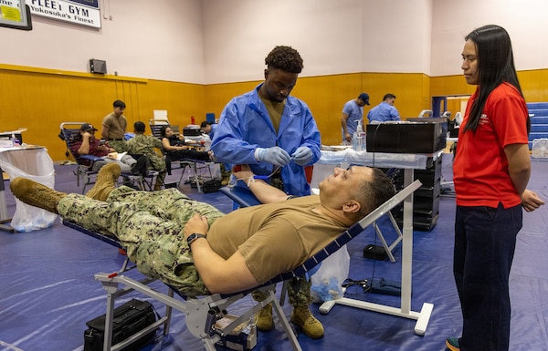 YOKOSUKA, Japan (Feb. 25, 2026) — Capt. Torrin Velazquez, director U.S. Naval Hospital Yokosuka prepares to give blood while an American Red Cross volunteer observes the collection process during a blood drive at Yokosuka’s Fleet Recreation Gym. U.S. Naval Hospital (USNH) Yokosuka, in partnership with the Armed Services Blood Bank Center (ASBBC) Okinawa, hosted a two-day blood drive at Commander, Fleet Activities Yokosuka’s Fleet Recreation Gym, Feb. 25–26, collecting 179 units of whole blood in support of operational readiness across the Indo-Pacific region. (U.S. Navy photo by Daniel Taylor/USNMRTC Yokosuka Public Affairs)