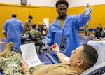 YOKOSUKA, Japan (Feb. 25, 2026) — A laboratory technician provides post donation instructions to Capt. Torrin Velazquez, director U.S. Naval Hospital Yokosuka during a blood drive at Yokosuka’s Fleet Recreation Gym. U.S. Naval Hospital (USNH) Yokosuka, in partnership with the Armed Services Blood Bank Center (ASBBC) Okinawa, hosted a two-day blood drive at Commander, Fleet Activities Yokosuka’s Fleet Recreation Gym, Feb. 25–26, collecting 179 units of whole blood in support of operational readiness across the Indo-Pacific region. (U.S. Navy photo by Daniel Taylor/USNMRTC Yokosuka Public Affairs)