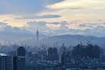 The Taipei skyline is visible through fog.