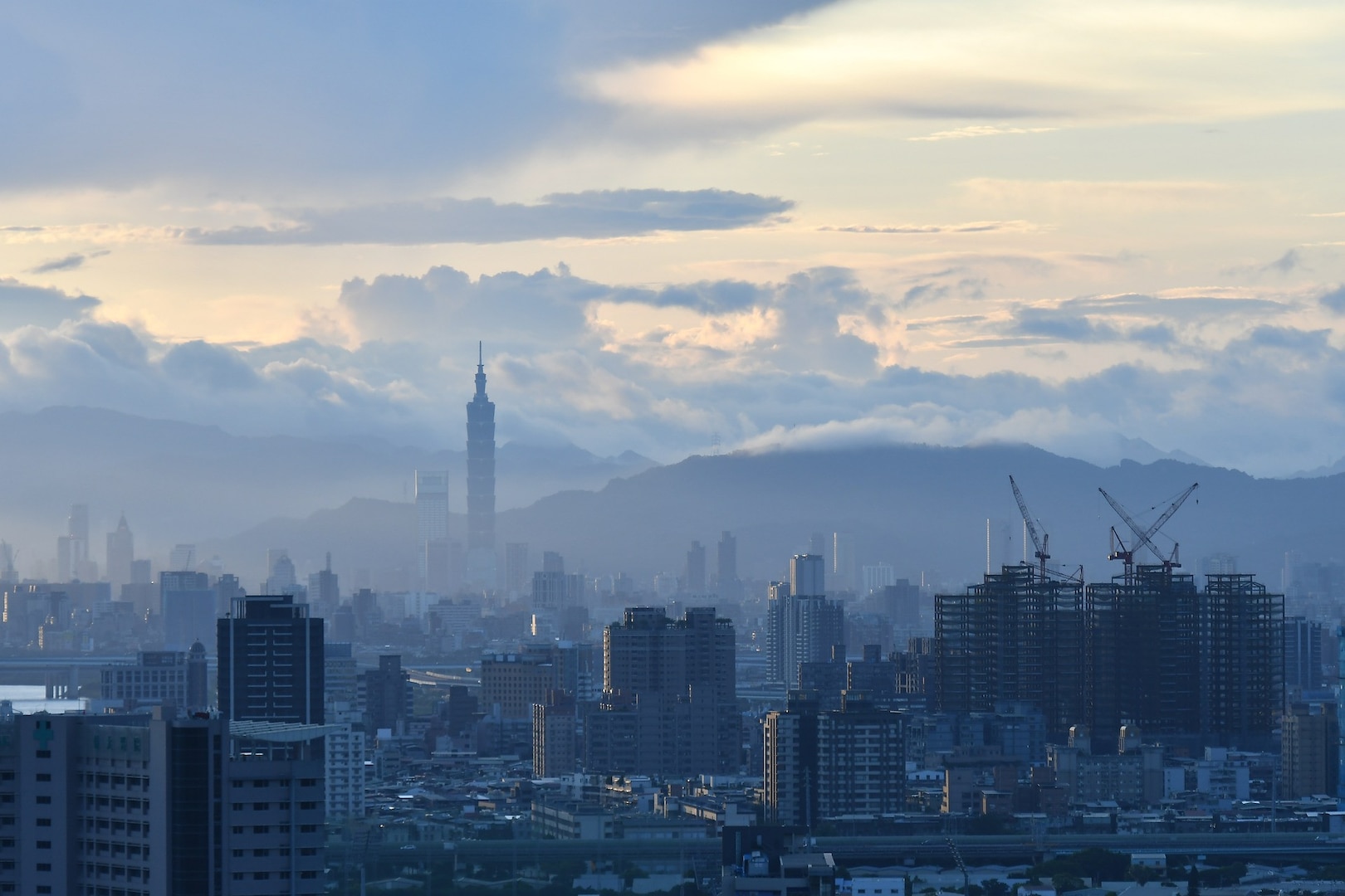 The Taipei skyline is visible through fog.