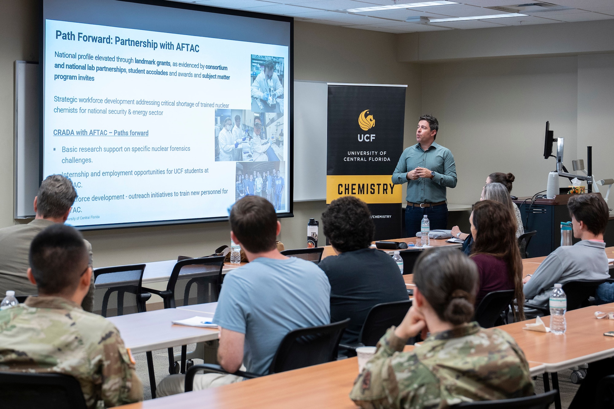 Associate Professor Dr. Vasileios Anagnostopoulos, University of Central Florida’s Director of Nuclear Regulatory Commission Fellowships, explains to his graduate students the Educational Partnership Agreement the university shares with the Air Force Technical Applications Center at Patrick Space Force Base, Fla., during AFTAC’s visit to UCF in the 2025 Fall Semester.  An EPA is a formal agreement between a defense laboratory and an educational institution to transfer and/or enhance technology applications and to provide technology assistance for all levels of education.  (U.S. Air Force photo by Matthew S. Jurgens)