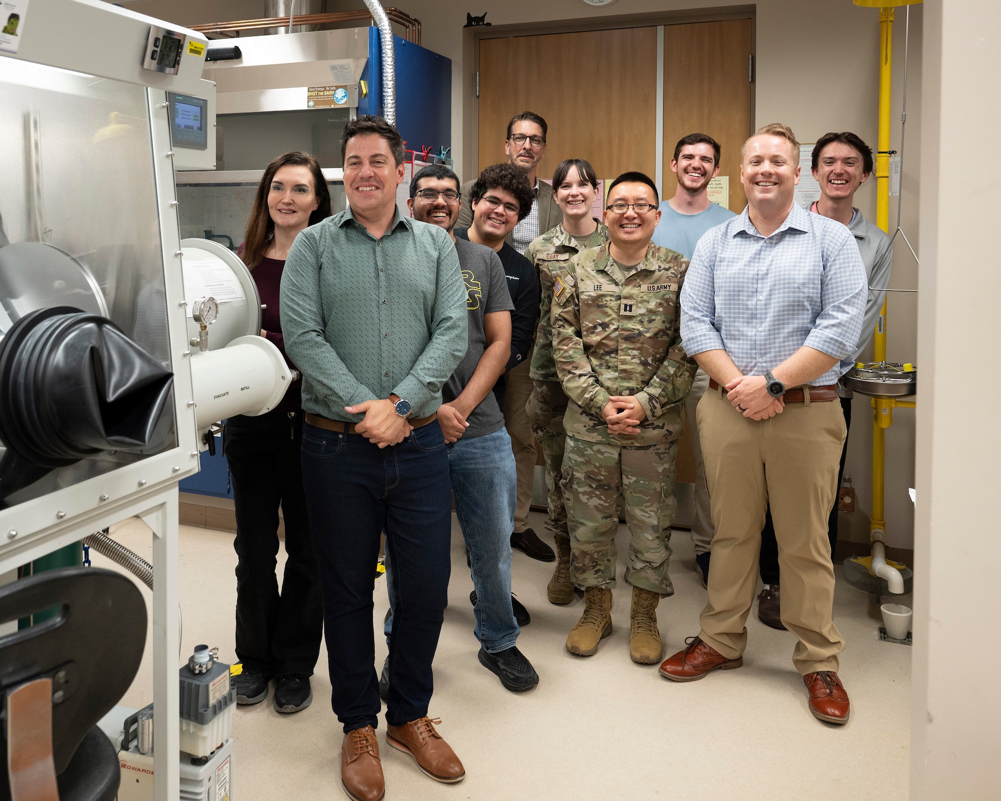 Associate Professor Dr. Vasileios Anagnostopoulos, University of Central Florida’s Director of Nuclear Regulatory Commission Fellowships (front left) poses with a group of his graduate students in the university’s radiochemistry lab during a visit from members of the Air Force Technical Applications Center.  Jonathan Holton (front right) AFTAC’s R&D Relationships branch chief, worked with Anagnostopoulos to secure an Educational Partnership Agreement between the two organizations to transfer and/or enhance technology applications and to provide technology assistance for all levels of education.  (U.S. Air Force photo by Matthew S. Jurgens)