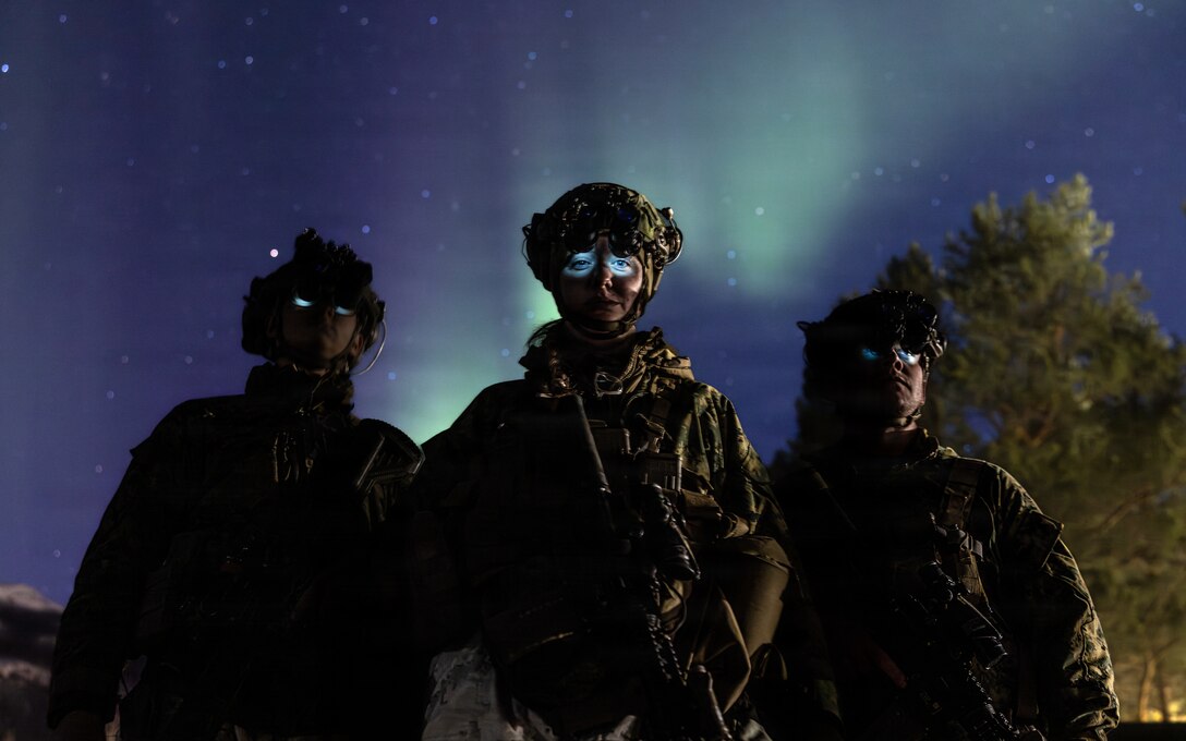 U.S. Marine Corps Cpl. Marek Krol, left, a rifleman, U.S. Navy Hospital Corpsman 3rd Class Savannah Dees, and Hospital Corpsman 3rd Class Keegan Farnsworth, all with 2nd Battalion, 6th Marine Regiment, 2nd Marine Division, pose for a photo at night wearing night vision goggles during exercise Cold Response 26 in Setermoen, Norway, March 14, 2026.