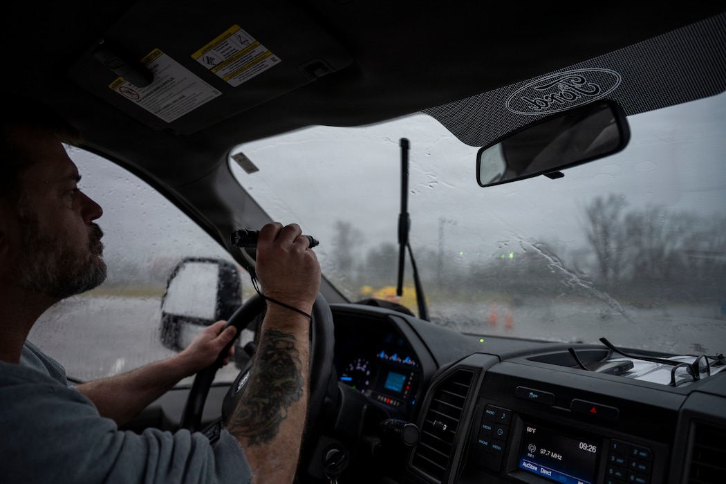 A pest management specialist uses a handheld laser to disperse geese from an airfield at Wright-Patterson Air Force Base to reduce wildlife hazards near aircraft.