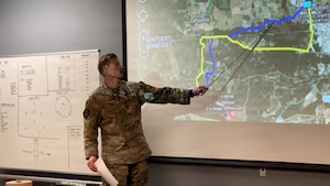 Man points at a board.