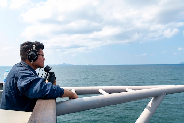 Retail Services Specialist 3rd Class Christopher Garcia Mendoza stands forward lookout aboard U.S. 7th Fleet flagship USS Blue Ridge (LCC 19) as the ship departs Laem Chabang, Thailand following a scheduled port visit, March 30, 2026.