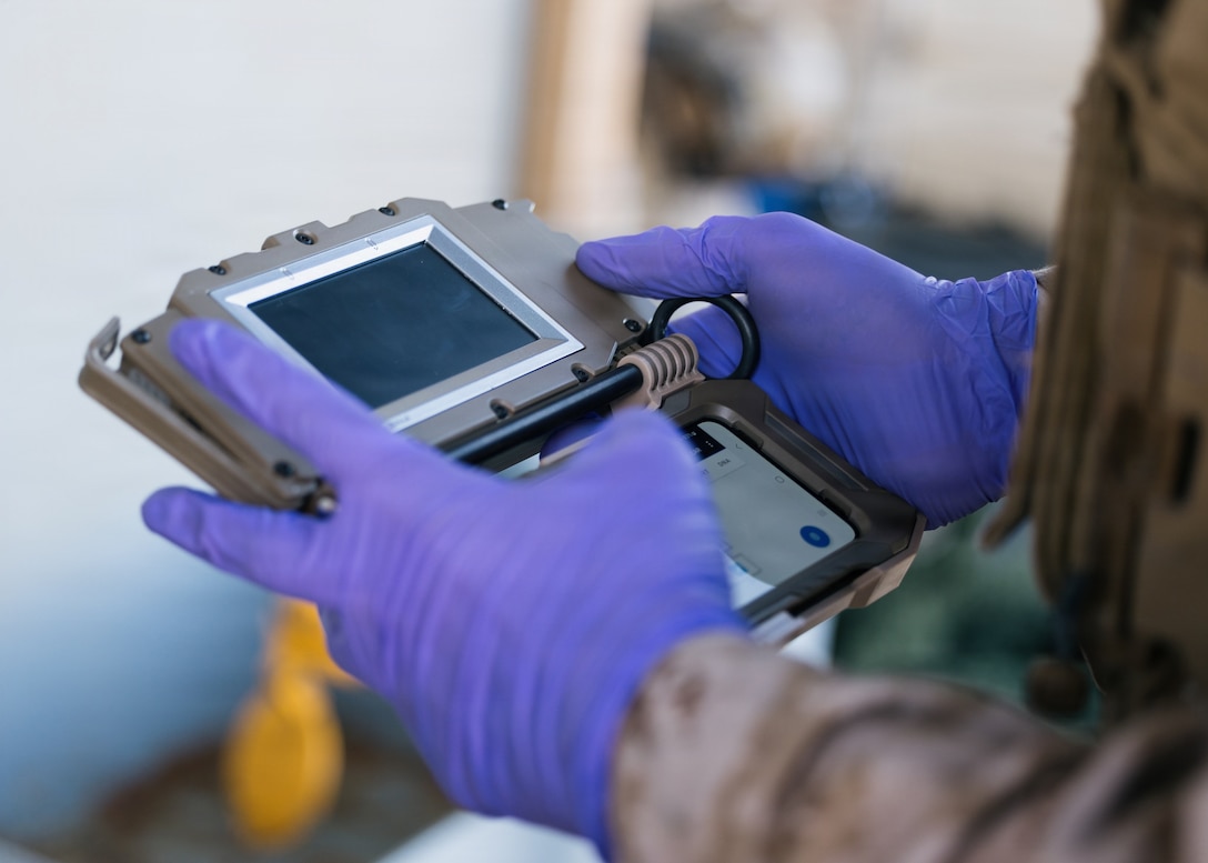 A U.S. Marine with the Maritime Raid Force, 11th Marine Expeditionary Unit, prepares to take biometrics from detainees aboard Henry J. Kaiser-class underway replenishment oiler USNS Patuxent during a visit, board, search and seizure exercise in the Pacific Ocean, Feb. 28, 2026. The 11th MEU is currently underway aboard the Boxer Amphibious Ready Group in the U.S. 3rd Fleet area of operations conducting integrated training that enhances lethality and warfighting readiness. (U.S. Marine Corps photo by Sgt. Joseph Helms)