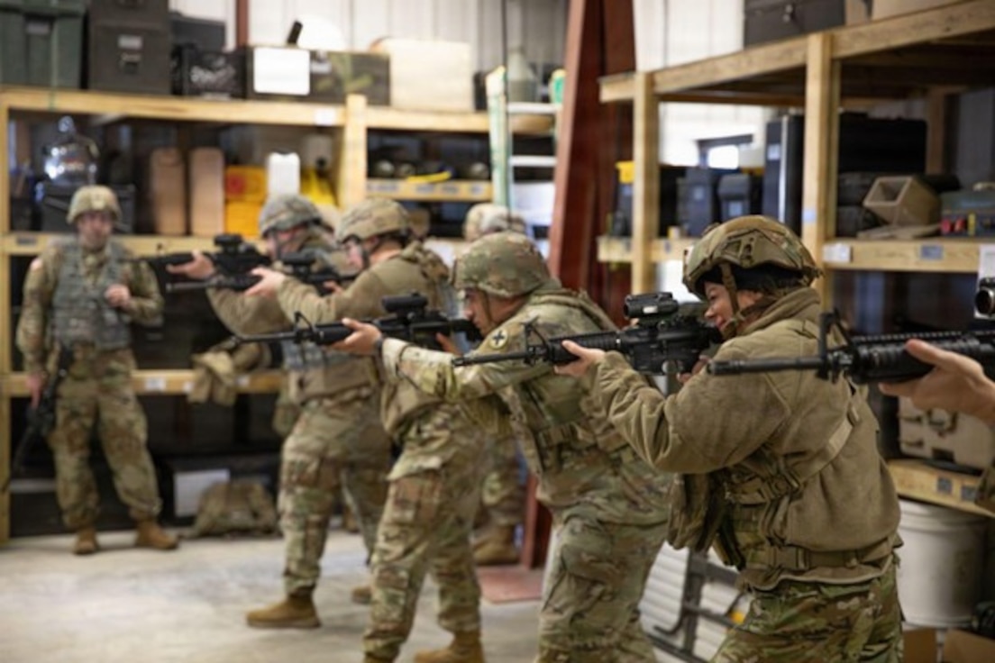 Illinois Army National Guard Soldiers practice weapons handling and aiming in an equipment storage building near a firing range at the Army National Guard training center in Marseilles, Illinois March 23, 2026.