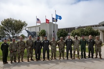 ACC command team pose with 350th Spectrum Warfare Wing command teams during an immersion at the 350th SWW, March 10, 2026.