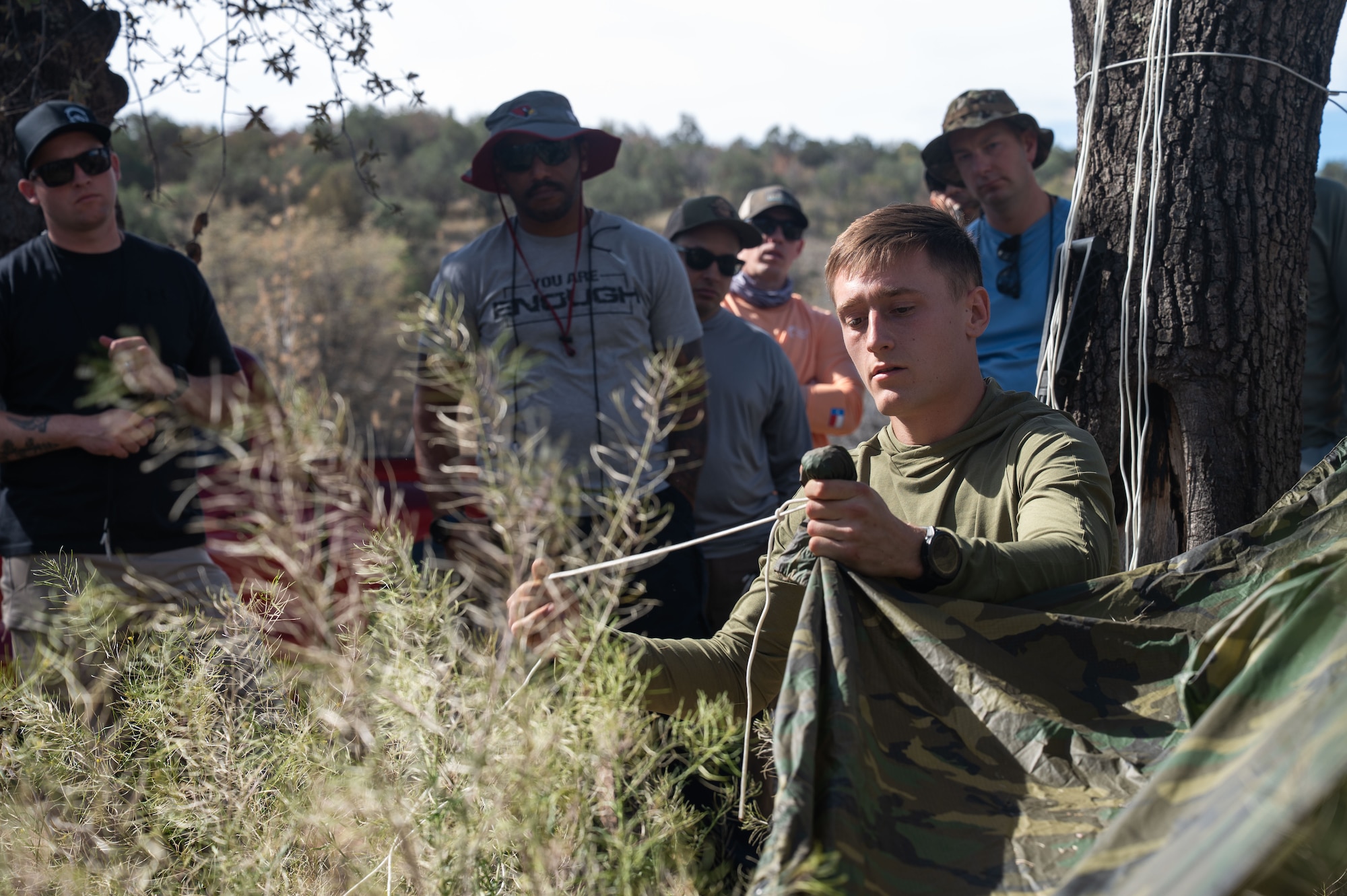 U.S. Air Force Senior Airman Chase Hilton, 563rd Operational Support Squadron survival, evasion, resistance, and escape specialist, teaches a course on knot tying during an offsite event for 355th Wing leaders at Gardner Canyon, Arizona, March 23, 2026. Activities included courses on knot tying, shelter building, fire starting and land navigation that required commanders and senior enlisted leaders to work together and rely on each other to complete the task. (U.S. Air Force photo by Airman 1st Class Jaden Kidd)