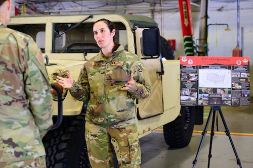 Service member presents at booth.