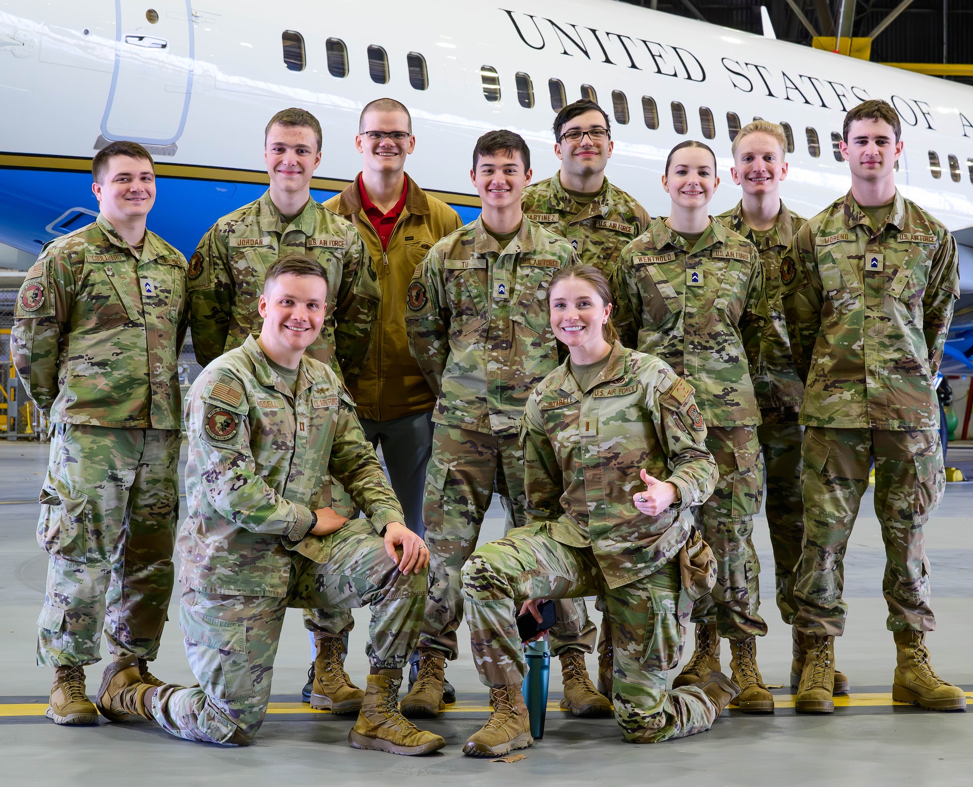 Cadets and service members pose for a photo.