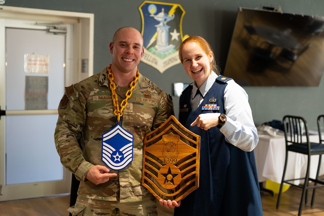 U.S. Air Force Maj. Kelly Griffith, 17th Training Wing commander, and Senior Master Sgt. select Jedadiah Bauman, 17th Training Wing inspections & unit self-assessment manager,  stand together for a photo.