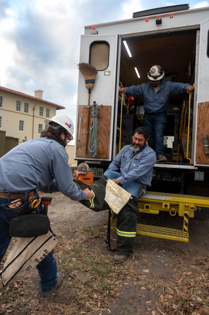 CPS Energy technicians done gear in preparation to shut down power to an office building for the exercise at Joint Base San Antonio-Fort Sam Houston on March 26, 2026. The power outage exercise was to help JBSA installations prepare for real-word scenarios. (U.S. Air Force photo by Melissa Hydrick)