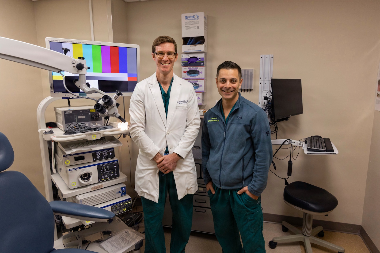 U.S. Army Maj. (Dr.) Charles Miller, and Army Lt. Col. (Dr.) Anthony Tolisano pose in a medical room.