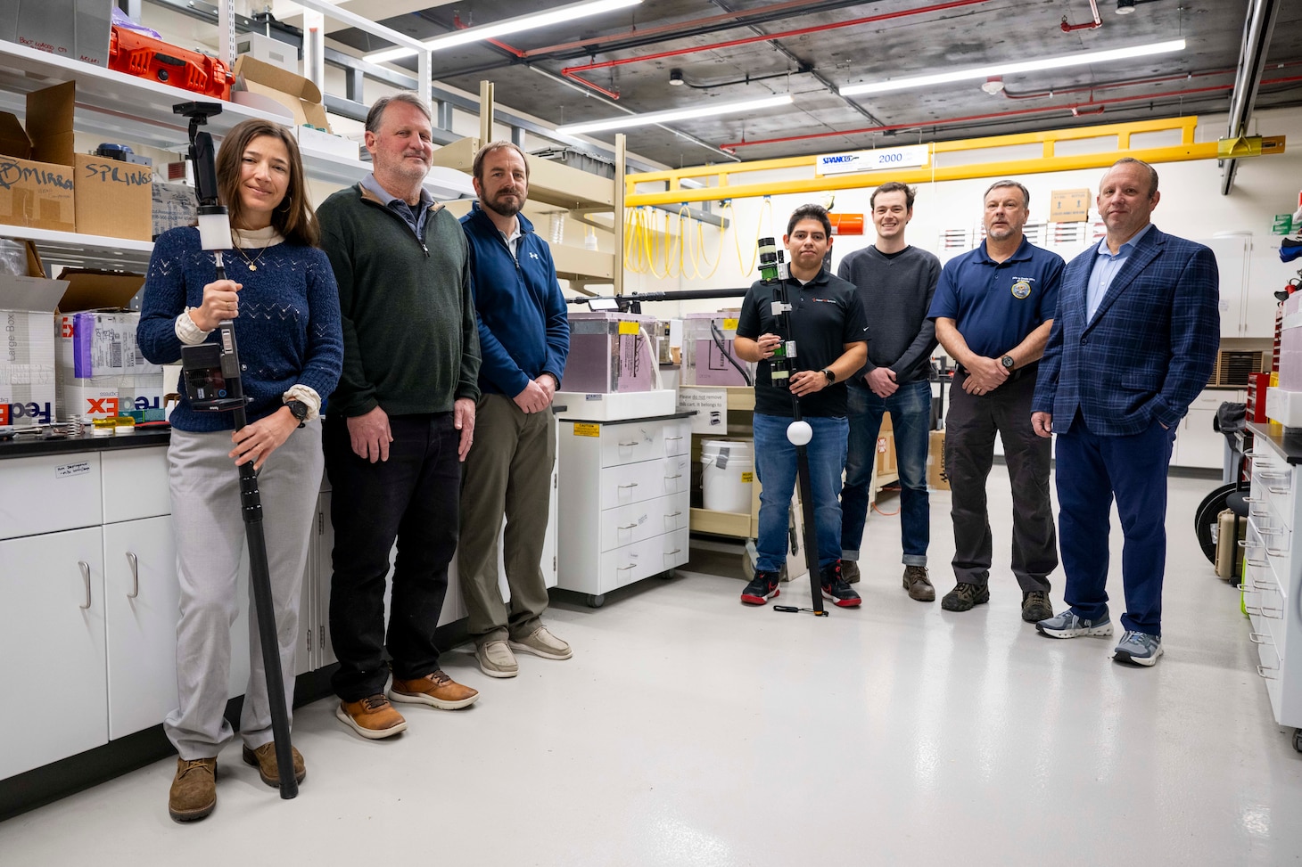 Members of the U.S. Naval Research Laboratory (NRL) team gather for a group photo with their Insertable Stalk Inspection System (ISIS360) in Washington, D.C., on March 3, 2026. The NRL-developed ISIS360 was utilized during inspections of the USS America to improve the safety, speed, and accuracy of the ship's tank inspections. (U.S. Navy photo by Sarah Peterson) RELEASED