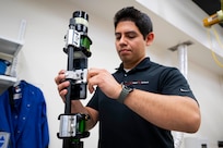 Kevin Marquez-Diaz, U.S. Naval Research Laboratory (NRL) materials engineer, attaches a smartphone to a fuel safe, explosion proof version of the Insertable Stalk Inspection System (ISIS) for remote image capturing in Washington, D.C., March 3, 2026. NRL developed this digital corrosion inspection device to improve the safety, speed, and accuracy of shipboard tank inspections within the Navy. (U.S. Navy photo by Sarah Peterson) RELEASED
