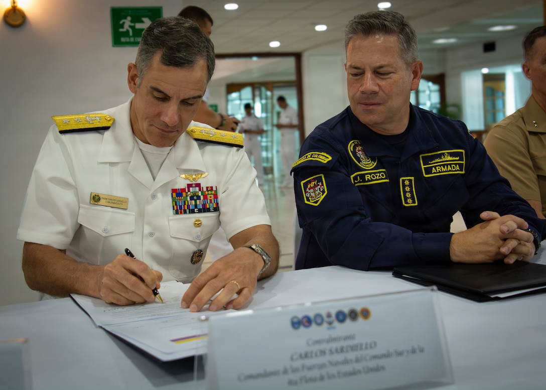 Rear Adm. Carlos Sardiello, commander of U.S. Naval Forces Southern Command/U.S. 4th Fleet, left, signs a memorandum of agreement as Vice Adm. Juan Ricardo Rozo Obregón, commander of the Colombian Navy, observes during the United States - Colombia Maritime Staff Talks closing ceremony March 27, 2026 in Cartagena, Colombia. Sardiello, led the U.S. delegation for the annual Maritime Staff Talks, reaffirming the enduring partnership between the two nations and outlining a path for future collaboration in the maritime domain. U.S. Naval Forces Southern Command/U.S. 4th Fleet serves as a trusted maritime partner for Caribbean, Central, and South American maritime forces, working to promote unity, security, and stability throughout the region.