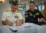 Rear Adm. Carlos Sardiello, commander of U.S. Naval Forces Southern Command/U.S. 4th Fleet, left, signs a memorandum of agreement as Vice Adm. Juan Ricardo Rozo Obregón, commander of the Colombian Navy, observes during the United States - Colombia Maritime Staff Talks closing ceremony March 27, 2026 in Cartagena, Colombia. Sardiello, led the U.S. delegation for the annual Maritime Staff Talks, reaffirming the enduring partnership between the two nations and outlining a path for future collaboration in the maritime domain. U.S. Naval Forces Southern Command/U.S. 4th Fleet serves as a trusted maritime partner for Caribbean, Central, and South American maritime forces, working to promote unity, security, and stability throughout the region.