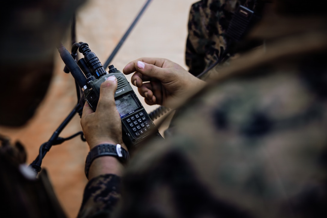 A Marine operates a radio
