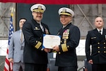 Capt. Randy Cruz (right), U.S. Naval Research Laboratory (NRL) commanding officer, presents a Meritorious Service Medal to Cmdr. Luis Levine, NRL Scientific Development Squadron ONE (VXS) 1 outgoing commanding officer, during the VXS-1 change of command ceremony at Naval Air Station Patuxent River in Patuxent River, Md. March 27, 2026. (U.S. Navy photo by Sarah Peterson)