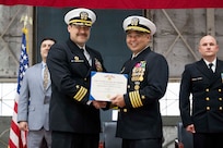 Capt. Randy Cruz (right), U.S. Naval Research Laboratory (NRL) commanding officer, presents a Meritorious Service Medal to Cmdr. Luis Levine, NRL Scientific Development Squadron ONE (VXS) 1 outgoing commanding officer, during the VXS-1 change of command ceremony at Naval Air Station Patuxent River in Patuxent River, Md. March 27, 2026. (U.S. Navy photo by Sarah Peterson)