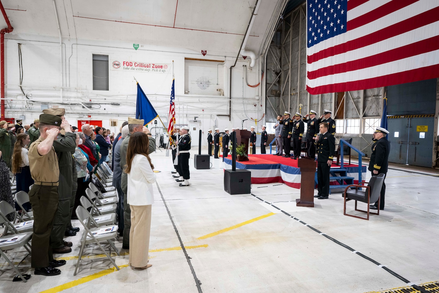 The U.S. Naval Research Laboratory Scientific Development Squadron ONE (VXS) 1 official party salutes during the national anthem at the VXS-1 change of command at the Naval Air Station Patuxent River in Patuxent River, Md. March 27, 2026. Cmdr. Luis Levine was relieved as the VXS-1 commanding officer by Cmdr. Andrew Vawter. (U.S. Navy photo by Sarah Peterson)