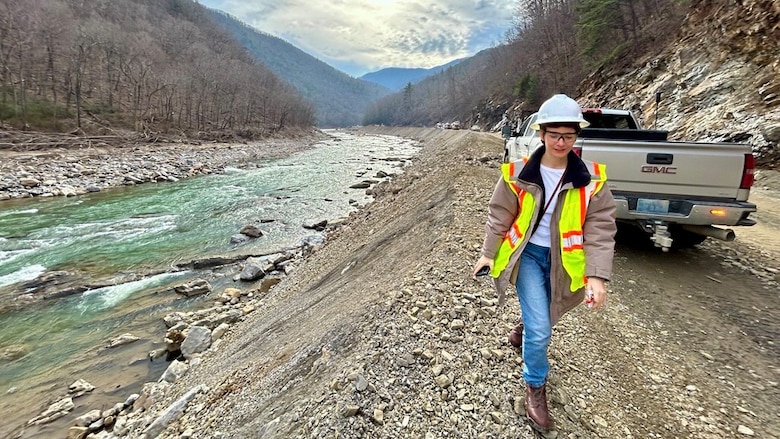 Kathryn Morris, assistant district counsel for the U.S. Army Corps of Engineers Nashville District, observes CSX railroad repairs while walking along the Nolichucky River near Erwin, Tenn., in January 2026. The site visit with Regulatory staff follows track reconstruction after Hurricane Helene. (USACE photo)