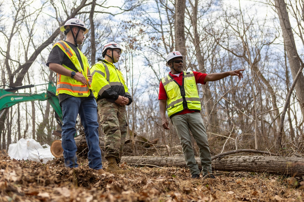 U.S. Army Corps of Engineers' Anthony Kearney (right), and Stephen Kitt, Omaha District Rapid Response Technical Center of Expertise, discuss current remediation operations with Baltimore District Commander Col. Francis B. Pera, south of the Rock Run culvert at the Potomac Interceptor collapse site in Washington, D.C., Mar. 11, 2026.
