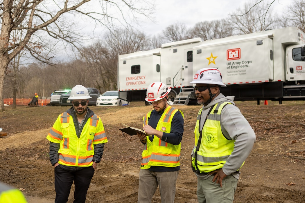 U.S. Army Corps of Engineers Stephen Kitt (center) and Anthony Kearney (right), Omaha District Rapid Response Technical Center of Expertise, discuss remediation efforts in Area 2 with interagency partners at the Potomac Interceptor collapse site in Washington, D.C., Mar. 8, 2026.