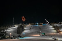 Fireworks burst above the snow-covered slopes at Bottineau Winter Park, North Dakota, March. 7, 2026. Bottineau Winter Park is an outdoor recreational park 90 min from Minot Air Force Base. (U.S. Air Force photo by Airman Joseline Chacon Monterroso)