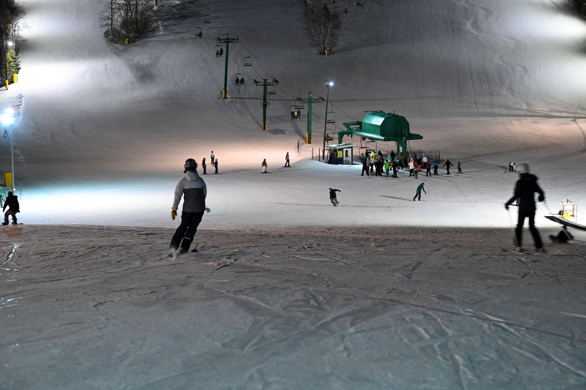 Skiers make their way down a lit slope at Bottineau Winter Park, North Dakota, March. 7, 2026. Bottineau Winter Park is an outdoor recreational park 90 min from Minot Air Force Base. (U.S. Air Force photo by Airman Joseline Chacon Monterroso)