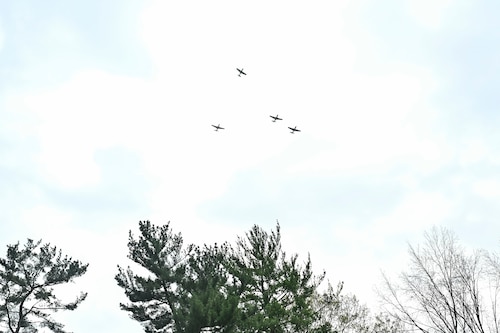 P-51 aircraft perform a flyover