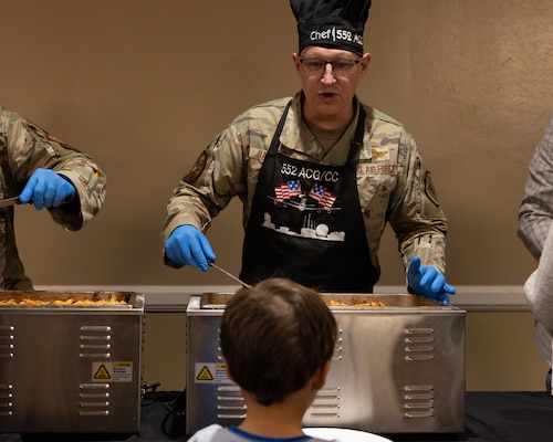 Man serving dinner to boy