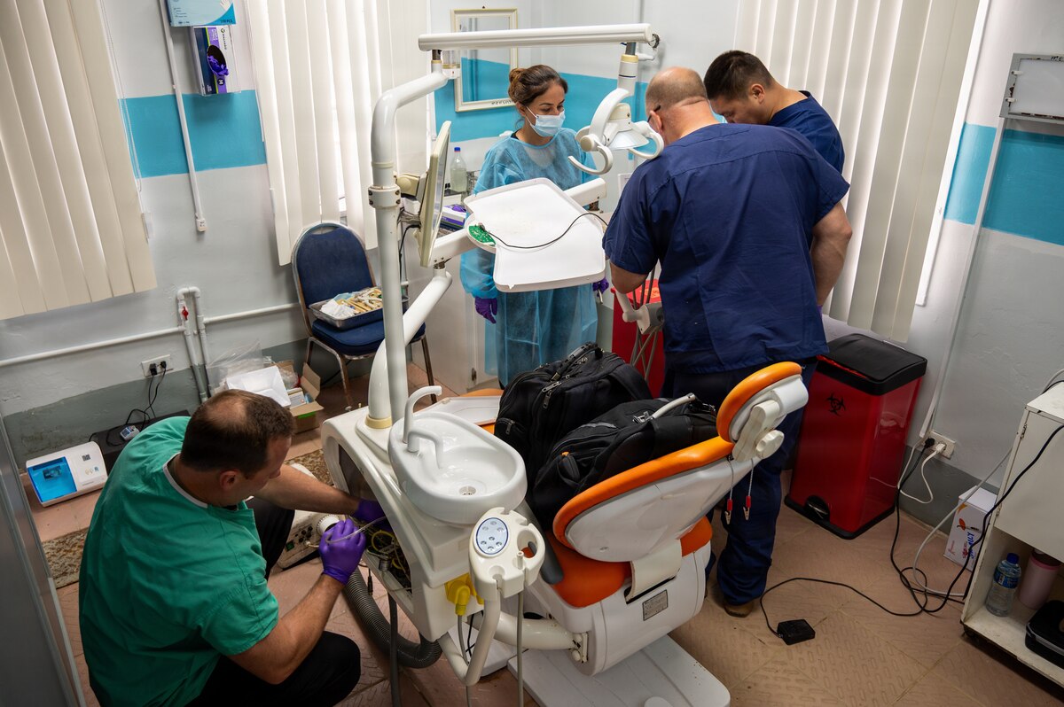 U.S. Air Force biomedical equipment technicians from the 920th Aeromedical Staging Squadron repair a dental chair at the Cheddi Jagan Dental School in Georgetown, Guyana, March 19, 2026. The Guyana Ministry of Health identified priority specialties based on national needs, enabling U.S. Air Force medical professionals to sharpen readiness skills while working alongside local partners to strengthen lasting partnerships during Lesser Antilles Medical Assistance Team 2026. (U.S. Air Force photo by Maj. Stephani Schafer)