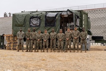 U.S. Marines with Food Service Company, Combat Logistics Regiment 37, 3rd Marine Logistics Group, pose for a photo in front of an Expeditionary Field Kitchen during the Korean Marine Exchange Program 26.1 in Camp Mujuk, South Korea, March 25, 2026. KMEP is a semi-annual exercise that provides opportunities for ROK Marine Corps and U.S. Marine Corps units to train together, improving their combined capabilities to deter threats and maintain peace on the Korean Peninsula. (U.S. Marine Corps photo by 1st Lt. Taiyo Tatara)