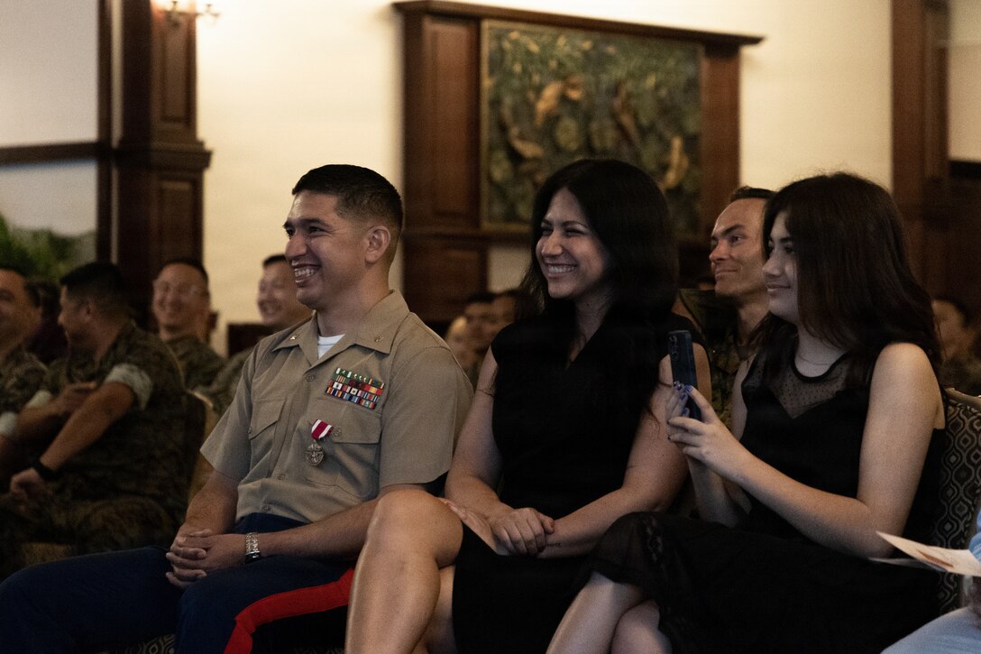 U.S. Marine Corps Maj. Gustavo Terrazas, left, G-6 deputy assistant chief of staff, Marine Wing Headquarters Squadron 1, 1st Marine Aircraft Wing sits with his family during his retirement ceremony at the Butler Officers’ Club, Okinawa, Japan, March 25, 2026. Terrazas retired after 26 years of honorable and dedicated service in the Marine Corps. (U.S. Marine Corps Photo by Cpl. Ryan Sotodavila)