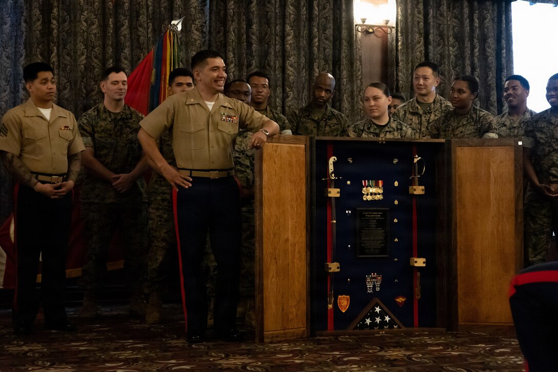 U.S. Marine Corps Maj. Gustavo Terrazas, G-6 deputy assistant chief of staff, Marine Wing Headquarters Squadron 1, 1st Marine Aircraft Wing, receives a shadow box during his retirement ceremony at the Butler Officers’ Club, Okinawa, Japan, March 25, 2026. Terrazas retired after 26 years of honorable and dedicated service in the Marine Corps. (U.S. Marine Corps Photo by Cpl. Ryan Sotodavila)
