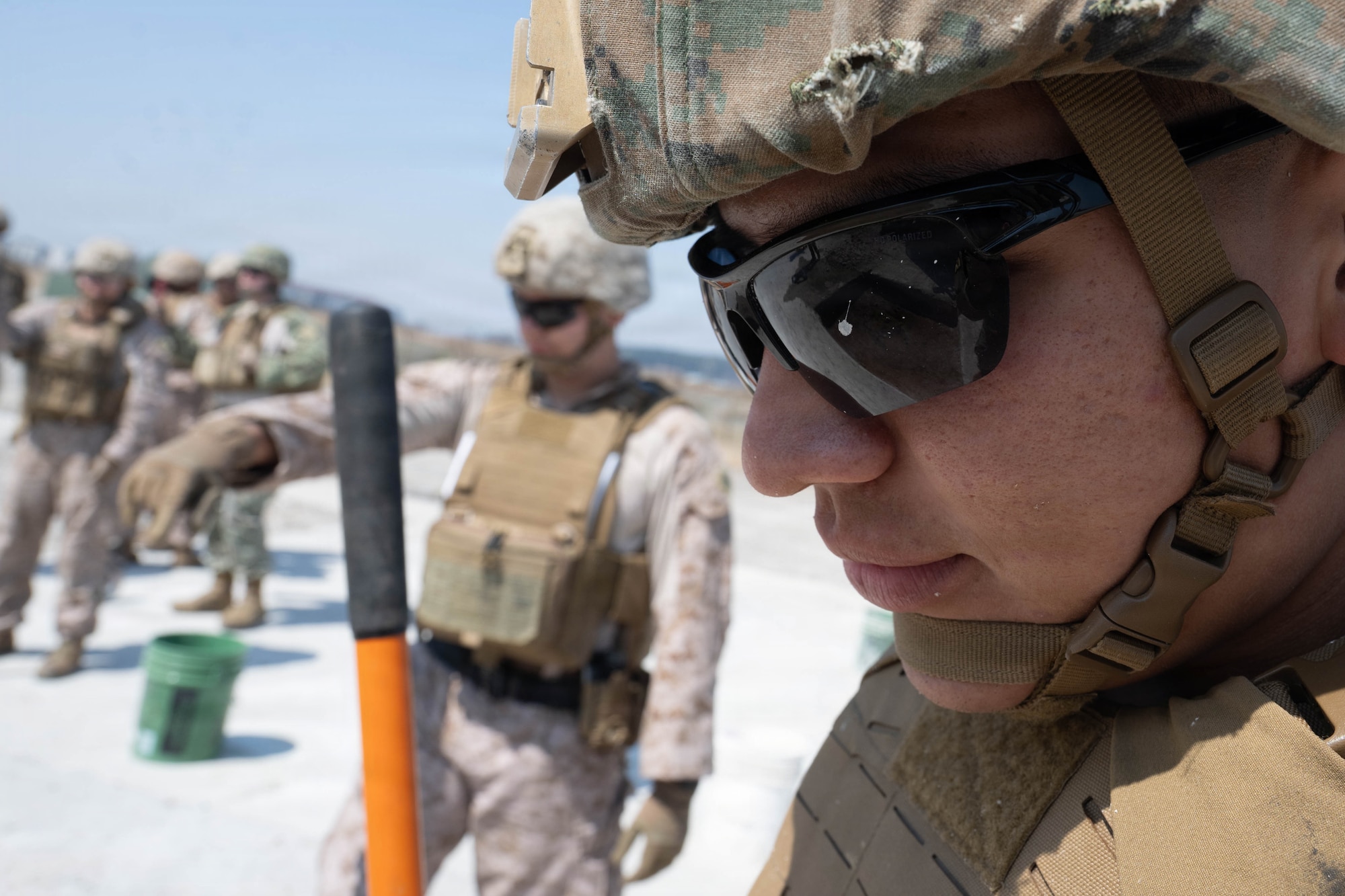 Marine observes operations.