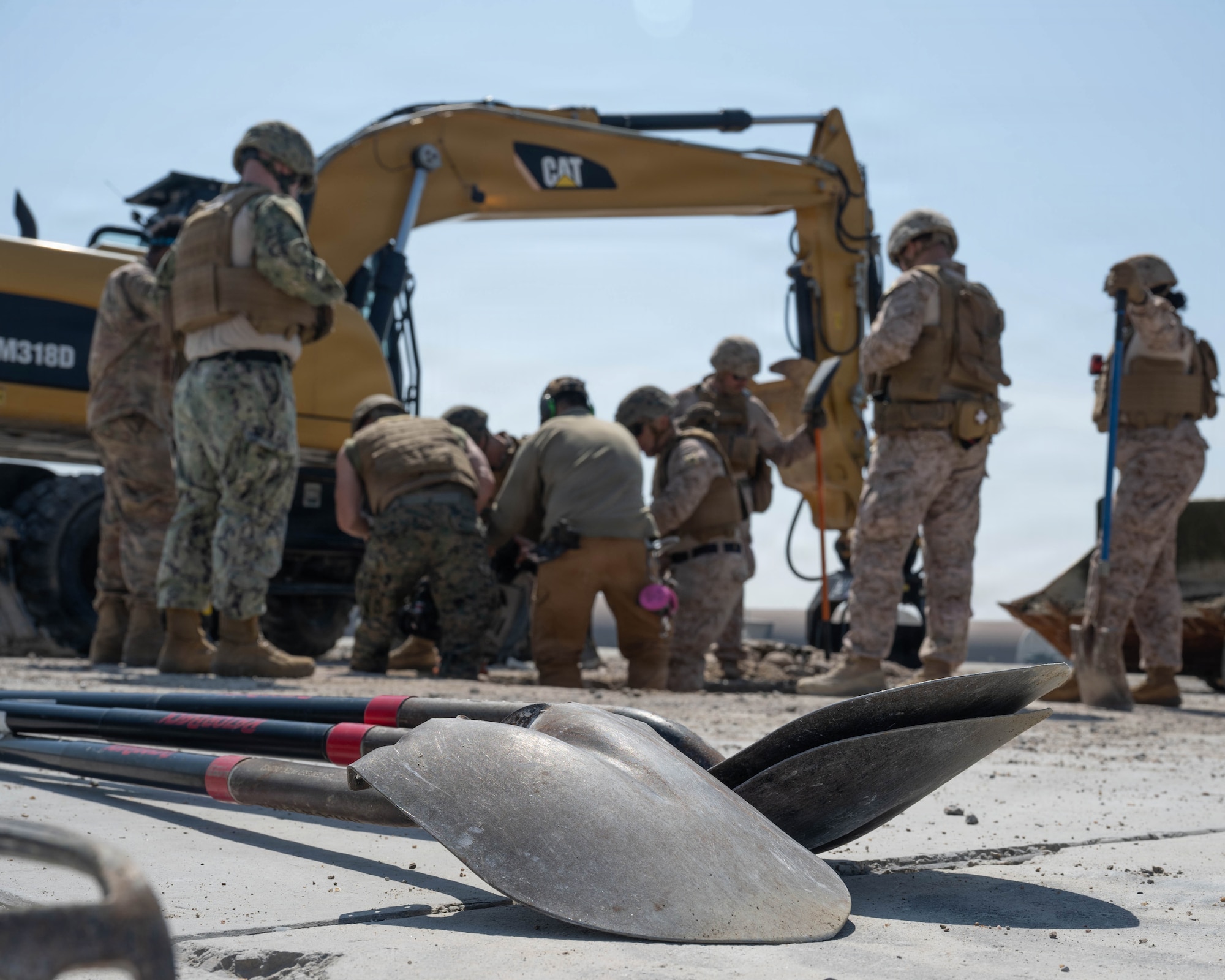 Service members clear out craters.