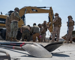 Service members clear out craters.