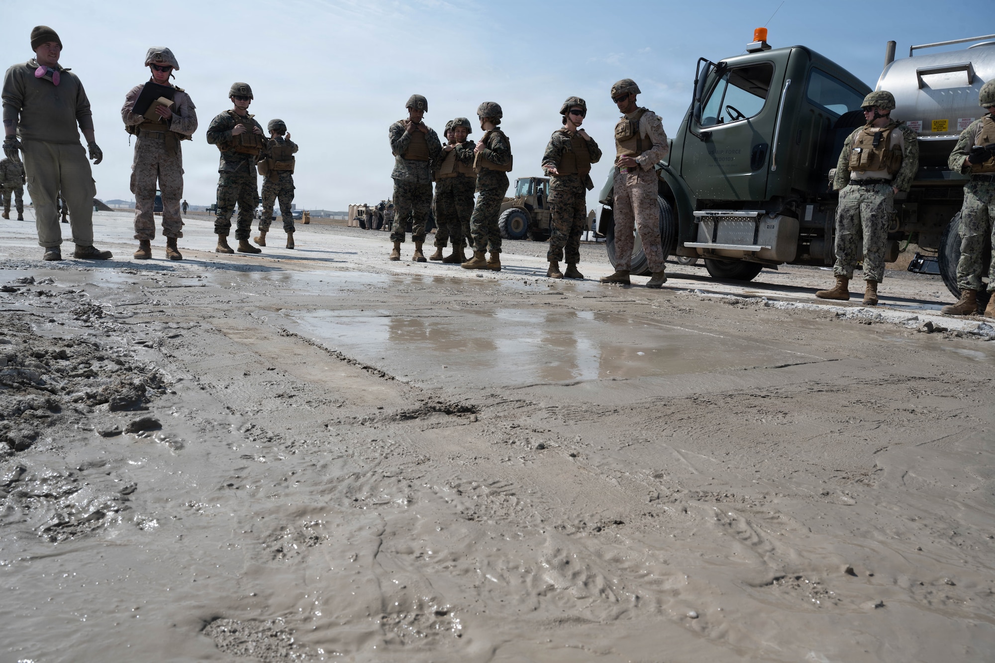 Service members observe rapid set concrete.