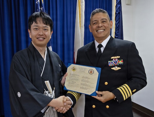 YOKOSUKA, Japan (March 20, 2026) — Capt. Donavon YapShing, deputy director of U.S. Naval Hospital Yokosuka, presents a diploma to Dr. Akimasa Takahashi during the Japanese National Physician Postgraduate Education Program graduation ceremony. U.S. Naval Hospital Yokosuka graduated six physicians from the yearlong program, strengthening bilateral medical readiness and patient care across the Indo-Pacific. (U.S. Navy photo by Daniel Taylor/USNMRTC Yokosuka Public Affairs)
